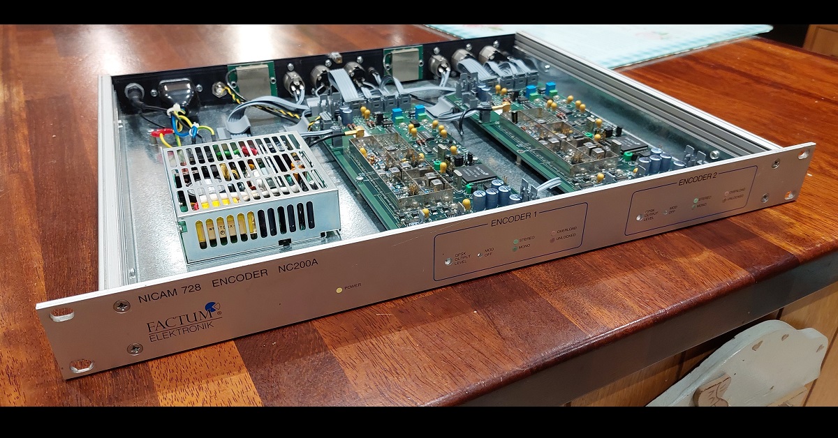 A 19 inch box with an aluminium front panel and the top cover removed, revealing two long circuit boards and a chassis power supply.