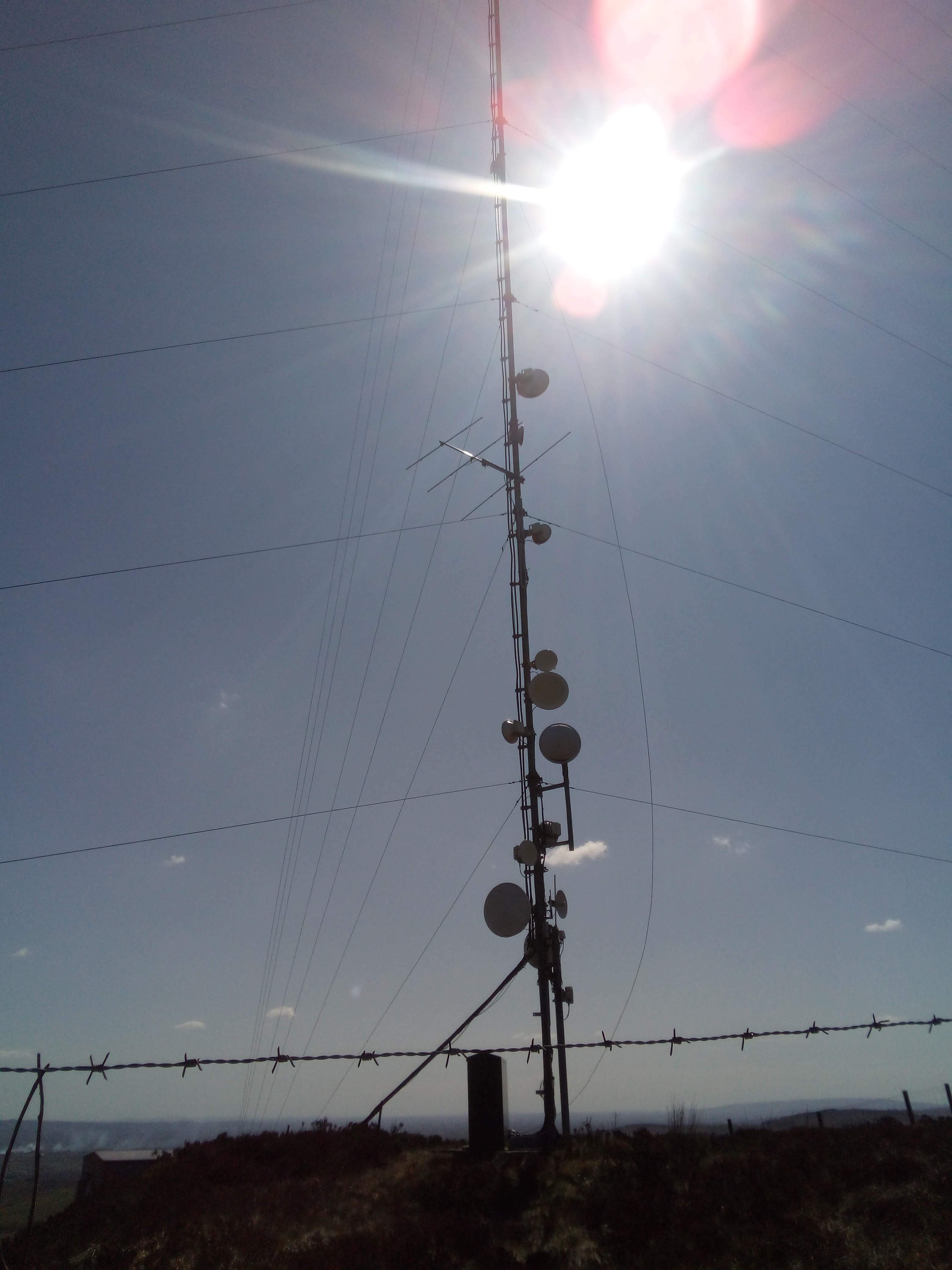 QR/DT mast, with similar microwave antennas and a large VHF yagi antenna. There's also a wire hanging down haphazardly from the highest of the dishes.