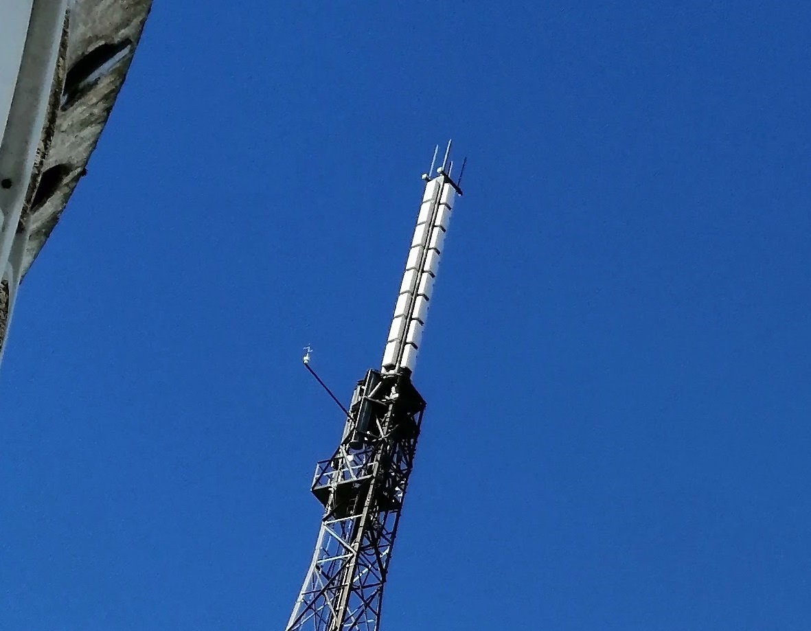 Again, the DTT aerial looks like white plastic sqaures, four around and eight tall. A small pole sticks out horizontally from the top carrying an anemometer.